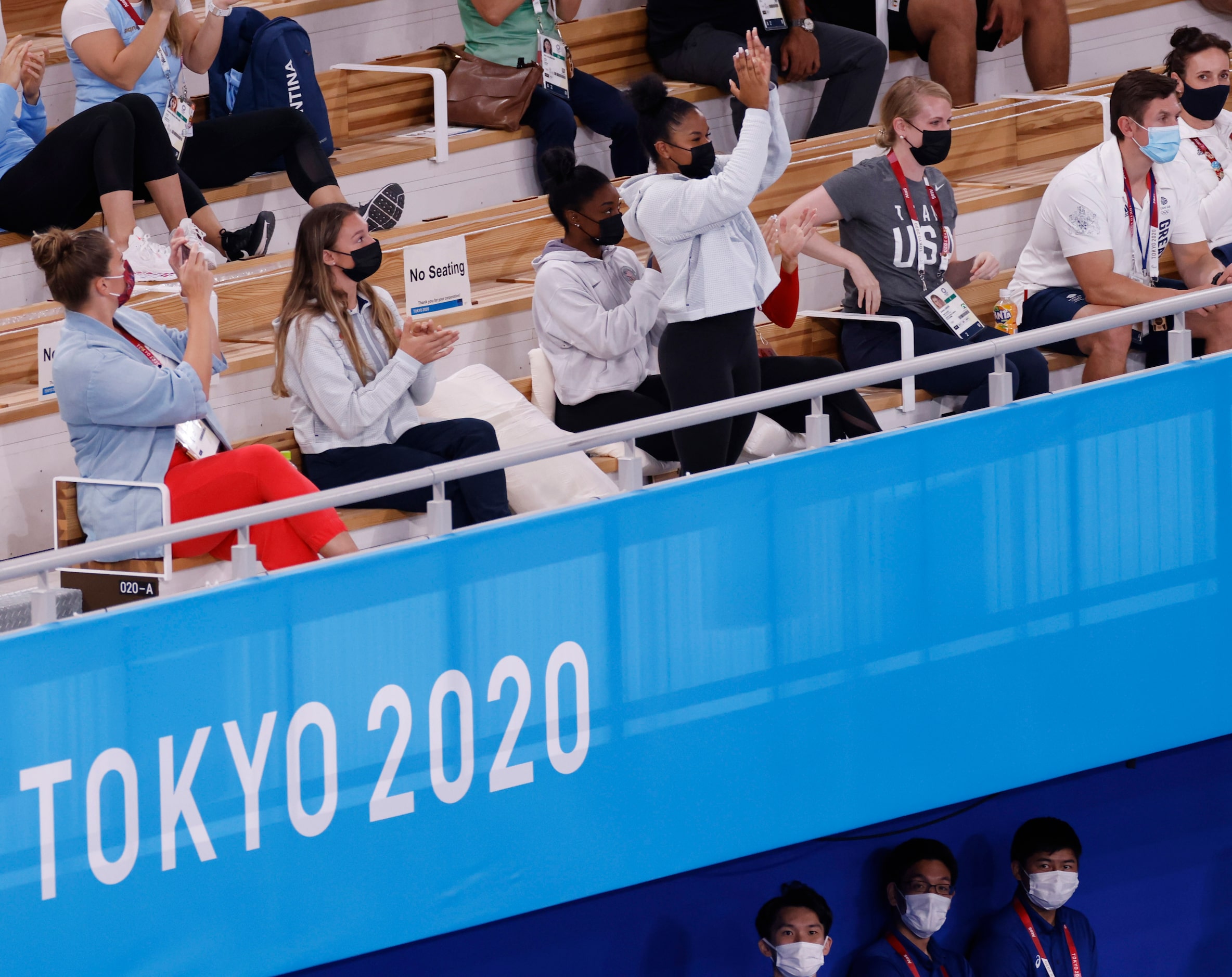 USA’s Jordan Chiles claps with teammates Grace McCallum (left), and Simone Biles (right of...