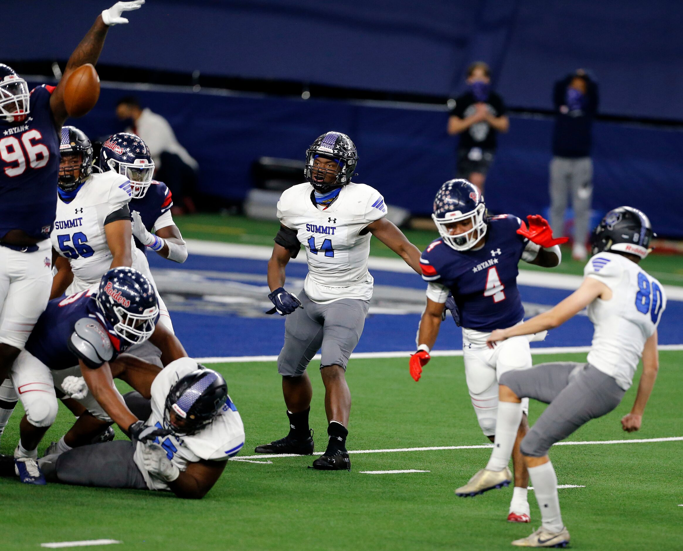 Mansfield Summit kicker Keaton Foster (80) tries to kick an extra point, but it is blocked...