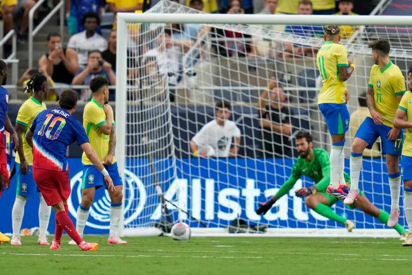 U.S. forward Christian Pulisic (10) scores a goal past Brazil goalkeeper Alisson Becker on a...