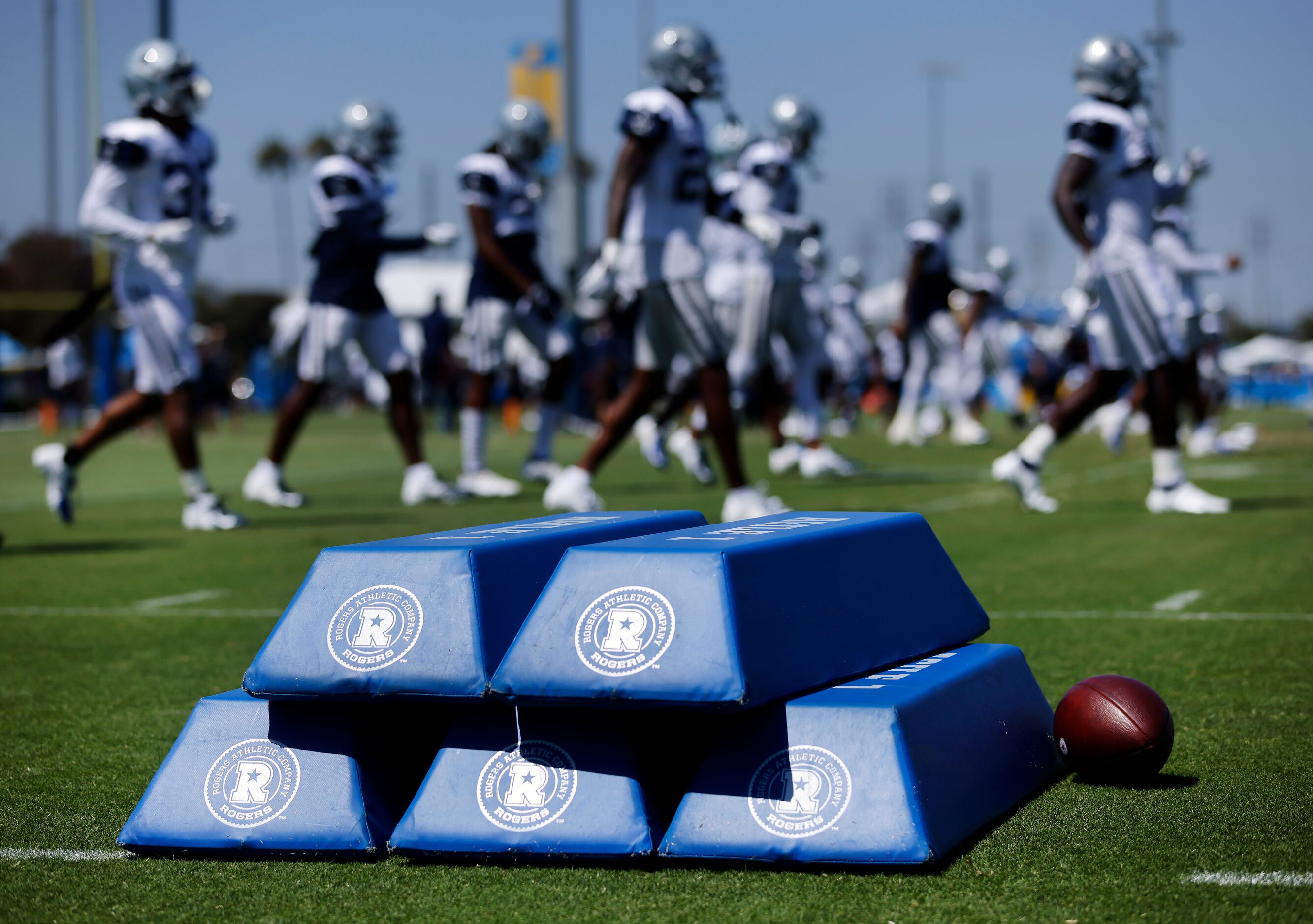 Dallas Cowboys football players warmup before their  joint practice at the Jack Hammett...