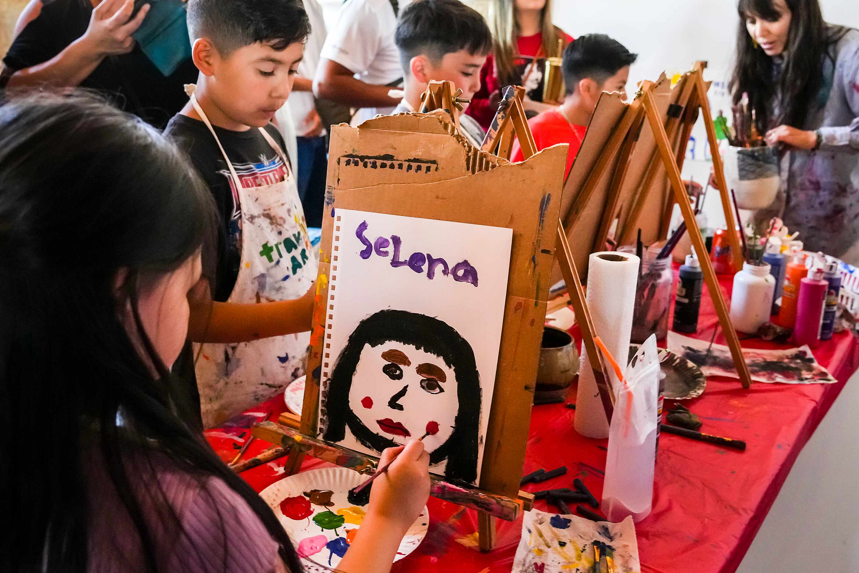Evelyn Almanza, 7, paints a picture of Selena Quintanilla-Pérez during the 214Selena...