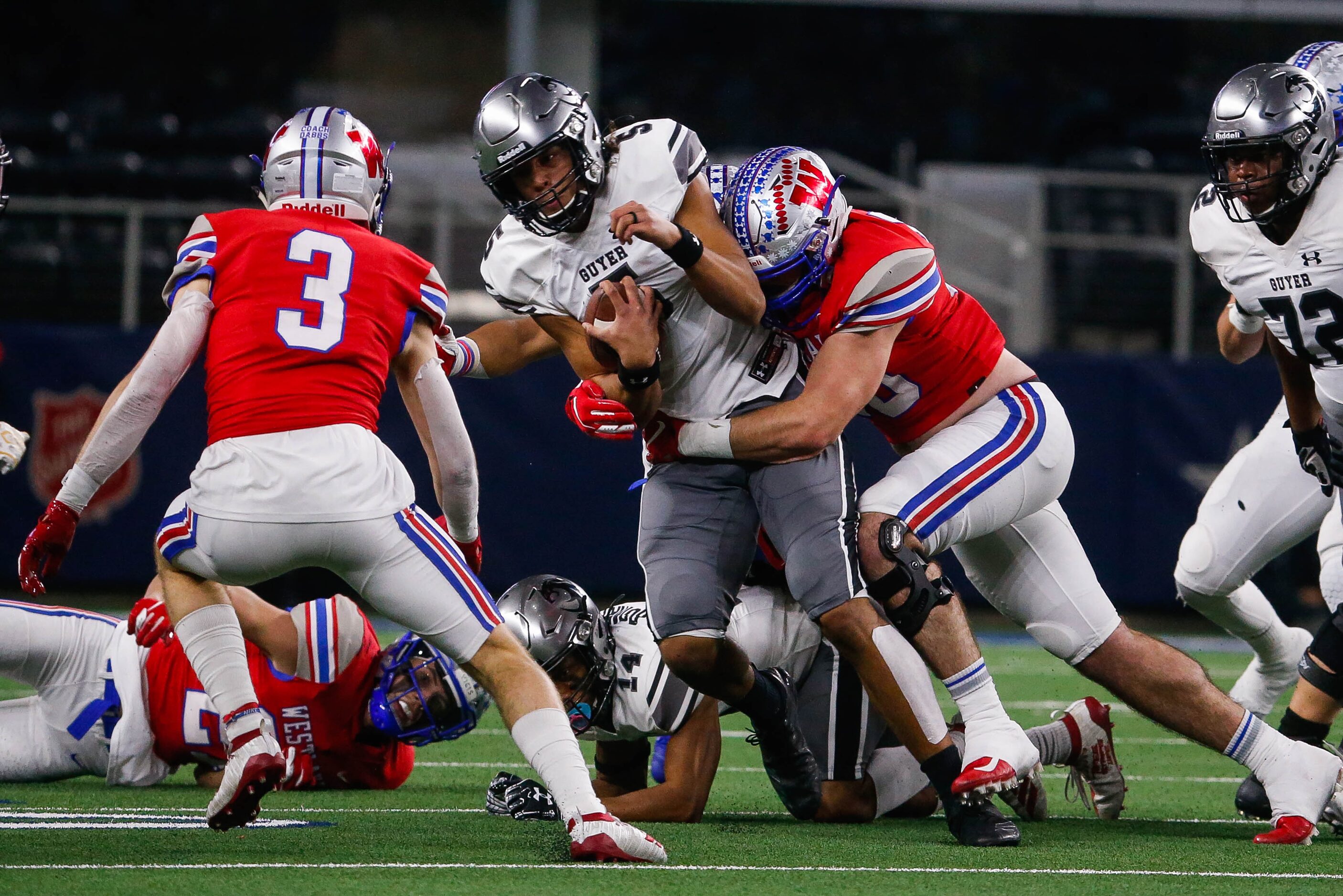 Denton Guyer's quarterback Eli Stowers (5) gets taken down by Austin Westlake's defense in...