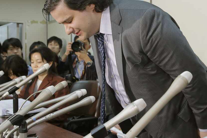 Mt. Gox CEO Mark Karpeles bows in apology at a press conference at the Justice Ministry in...