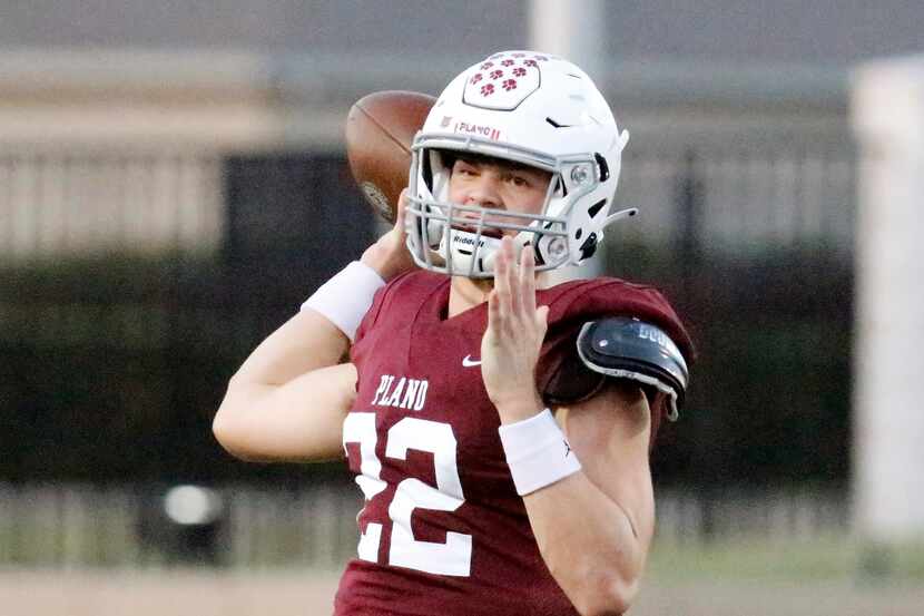 Plano Senior High School quarterback Drew Forkner (22) throws a pass during the first half...
