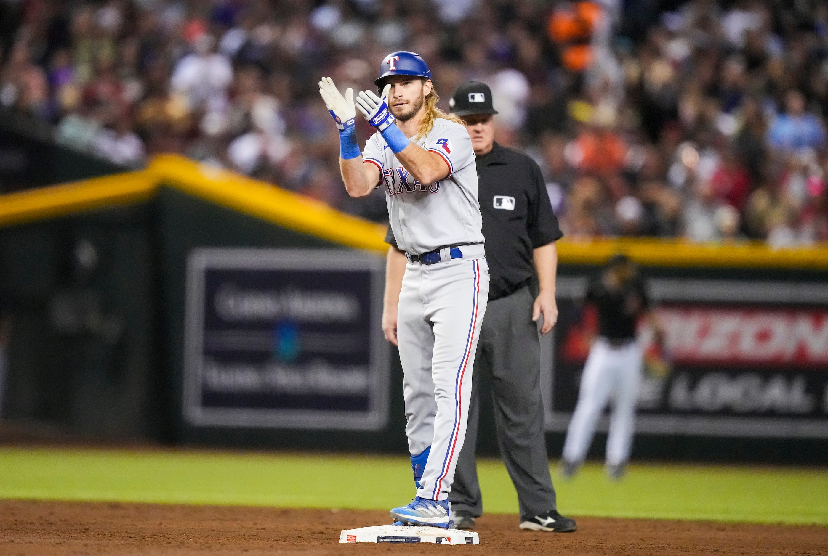 Texas Rangers right fielder Travis Jankowski celebrates at second base after hitting a...