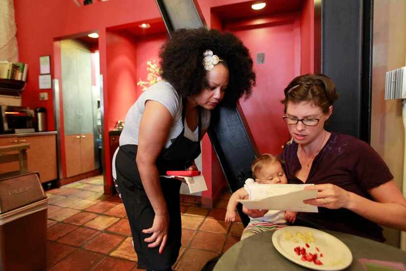 
Caffe 817’s Emily Goldenberg (right), with employee Shuana Nichols, had to raise menu...