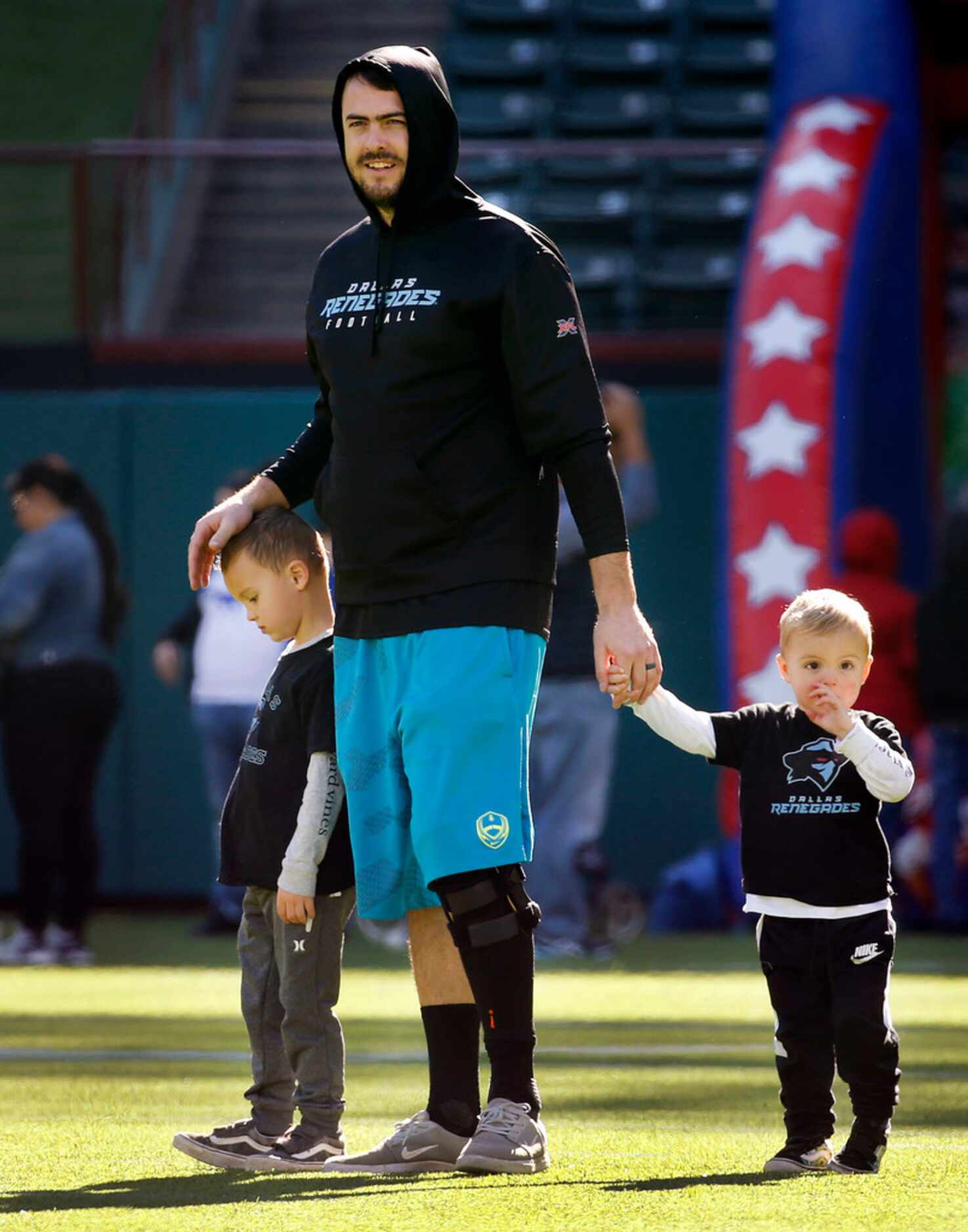 Dallas Renegades inured quarterback Landry Jones watches his teammates practice with his...