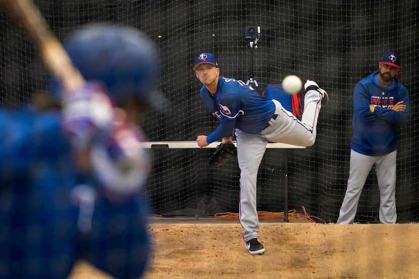 Texas Rangers pitcher Drew Smyly throws live batting practice to infielder Patrick Wisdom in...