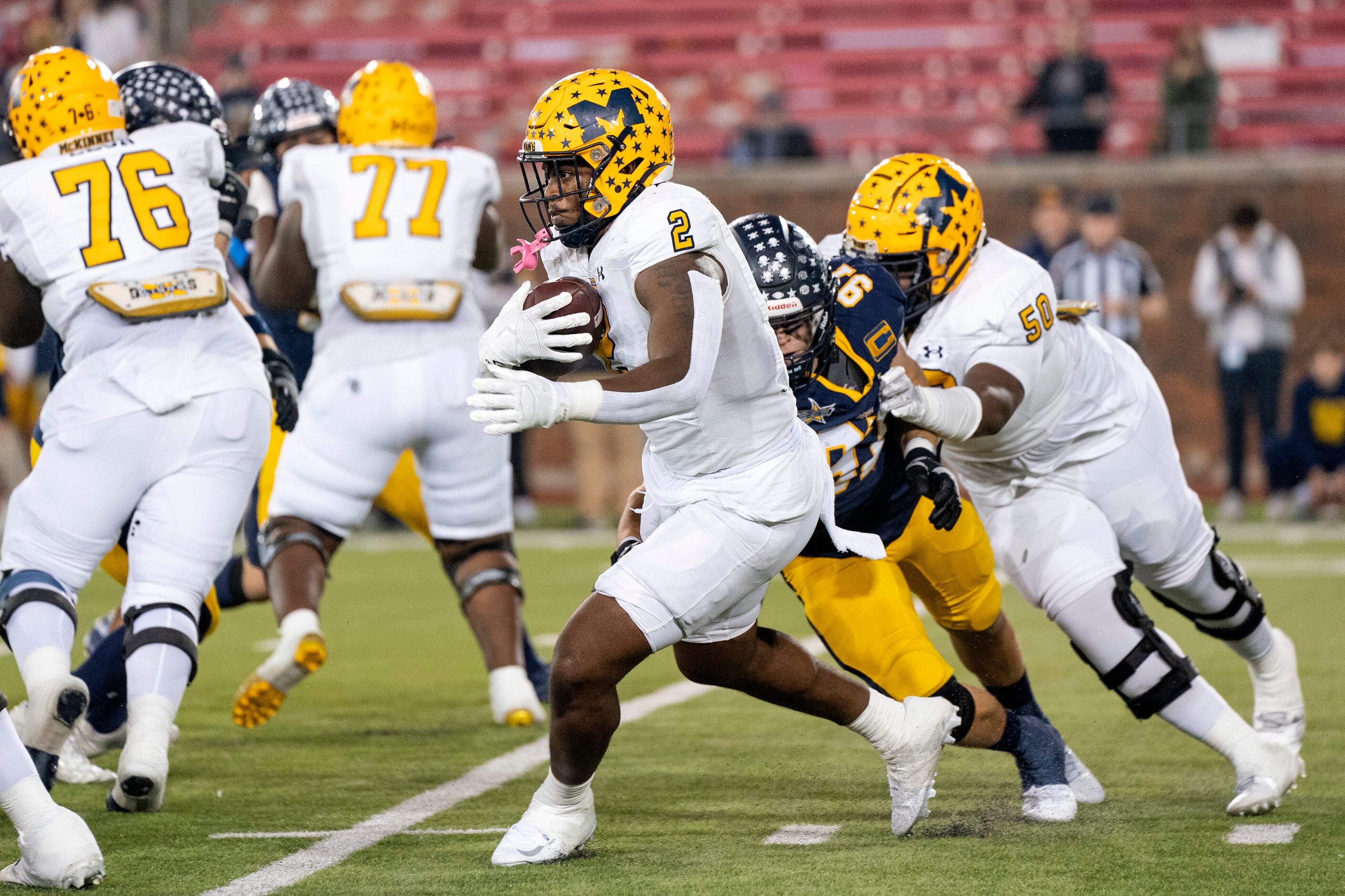 McKinney senior running back Bryan Jackson (2) turns the ball up against Highland Park...