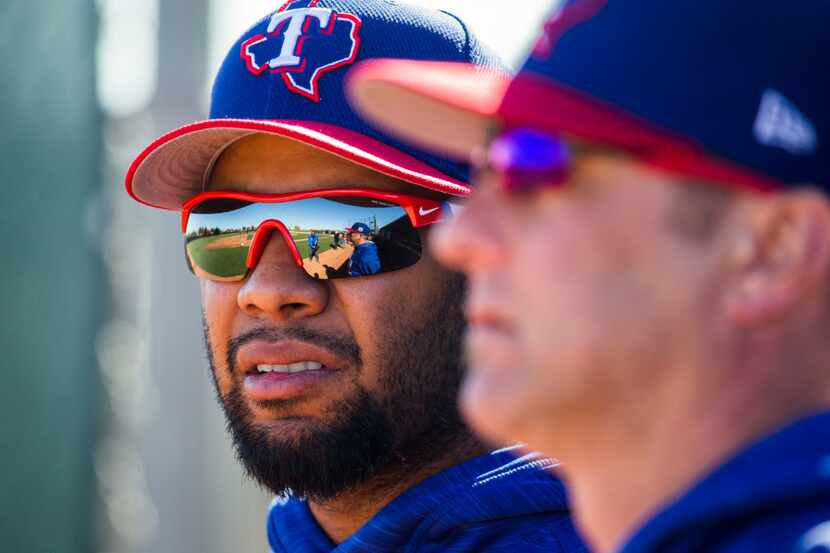 Texas Rangers shortstop Elvis Andrus (1) talks to hitting coach Anthony Iapoce (9) about not...