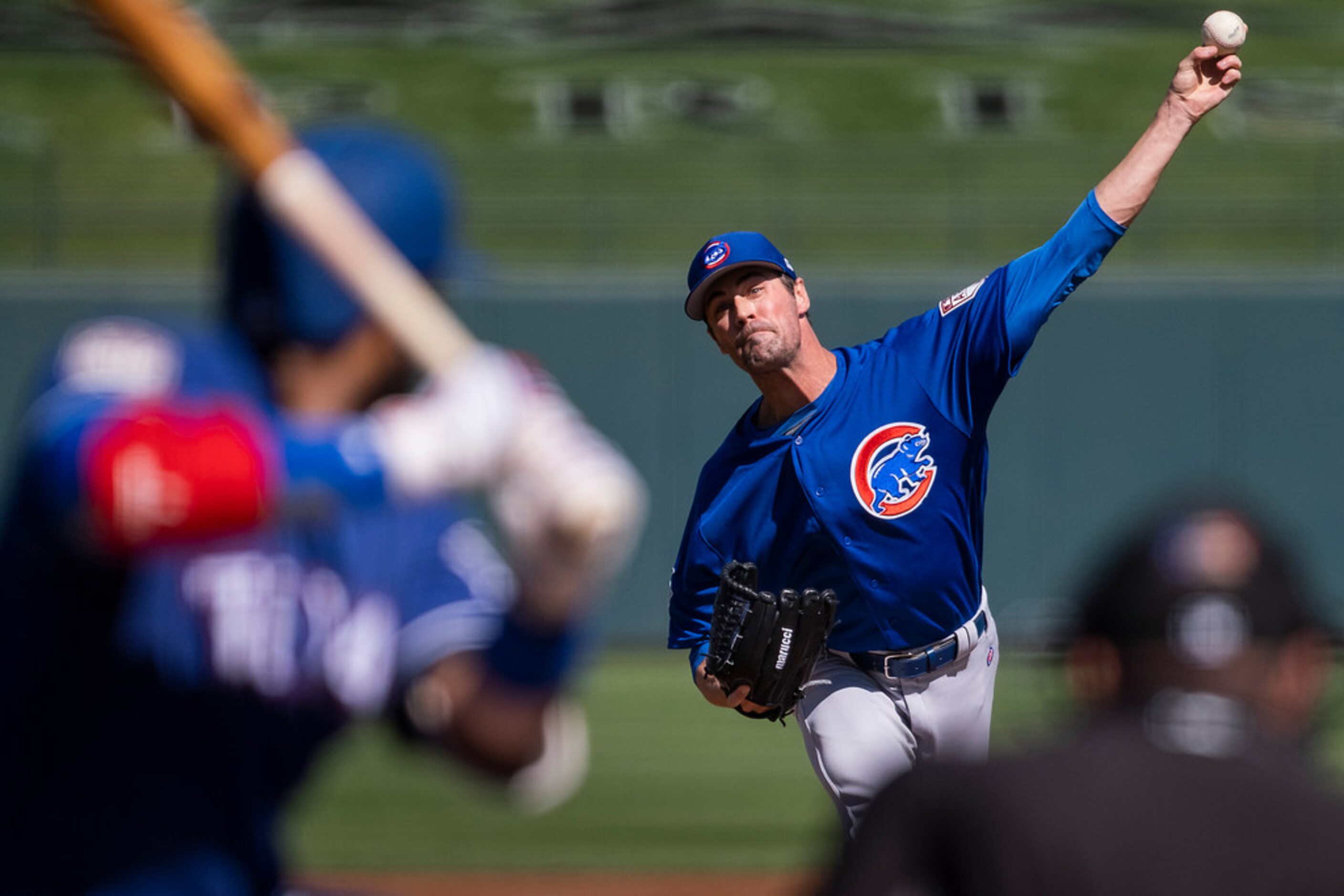 Chicago Cubs starting pitcher Cole Hamels delivers a pitch to Texas Rangers shortstop Elvis...