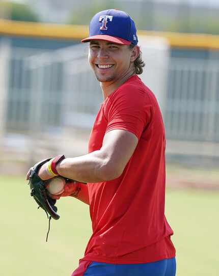 Texas Rangers top pitching prospect Ricky Vanasco smiles while he rehabs with warm-up tosses...