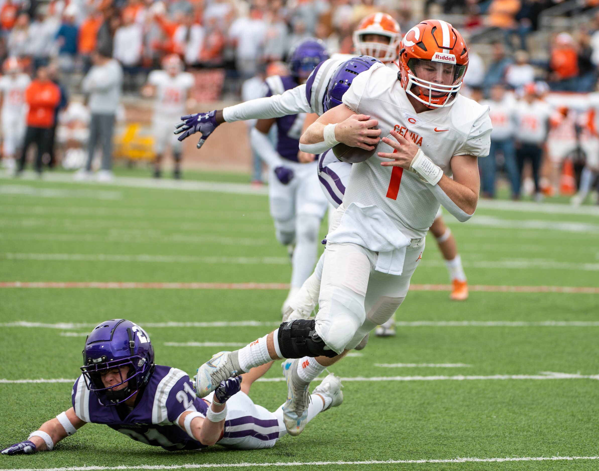 Celina quarterback Noah Bentley (1) runs upfield past Anna free safety Roman Frazier (21) in...