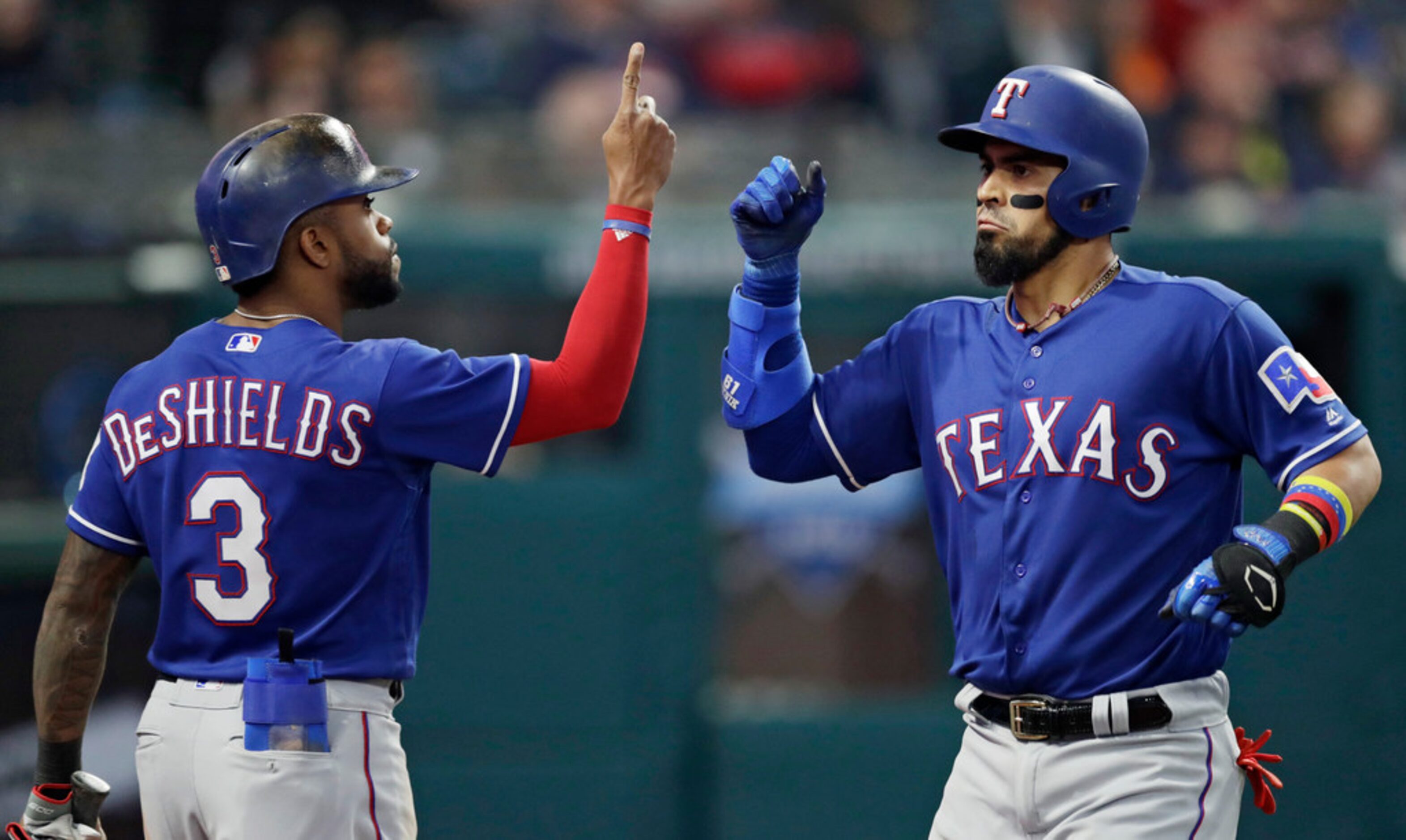 Texas Rangers' Robinson Chirinos is congratulated by Delino DeShields after Chironis hit a...