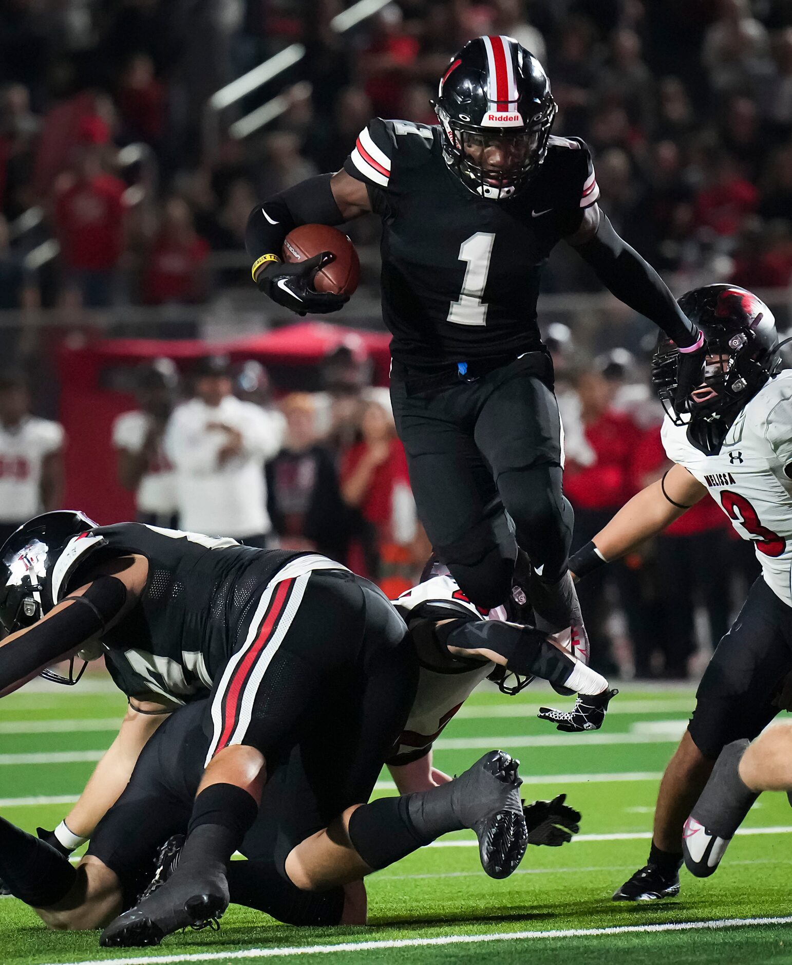 Lovejoy’s Kyle Parker (1) leaps over Melissa linebacker Landen Brandow (25) during the first...