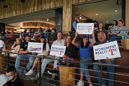 Monument employees attend a Texas
Rangers game at Globe Life Field.