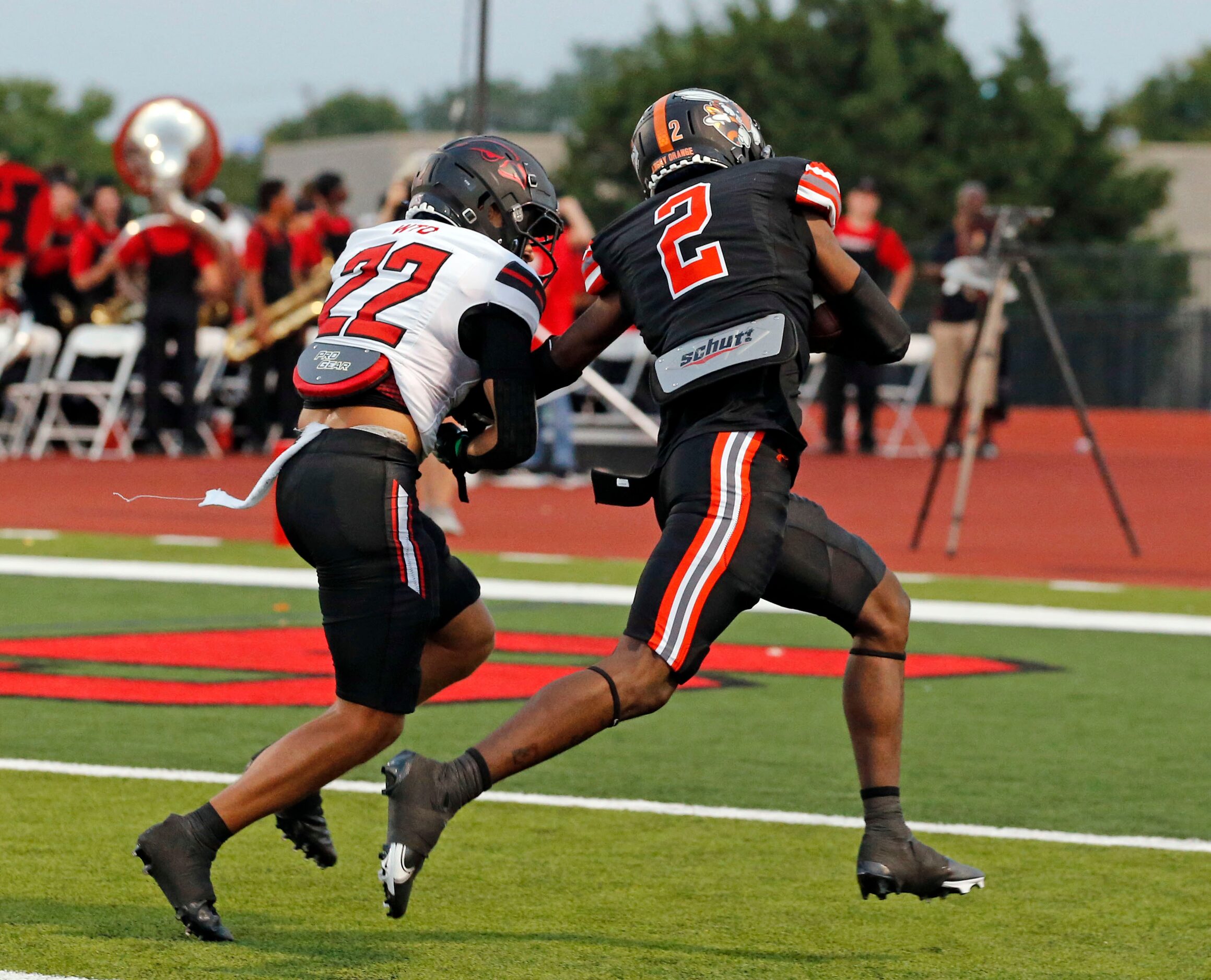 Rockwall high’s Quintero Jones (2) gets past Rockwall-Heath defender Patrick Donaldson (22)...