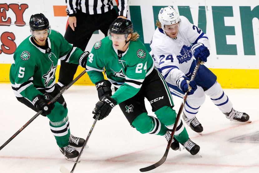 Dallas Stars left wing Roope Hintz (24) steals the puck from Toronto Maple Leafs right wing...