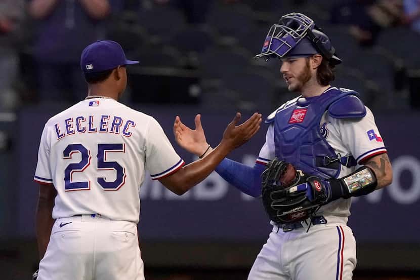 Texas Rangers closer Jose Leclerc (25) is congratulated by catcher Jonah Heim after logging...