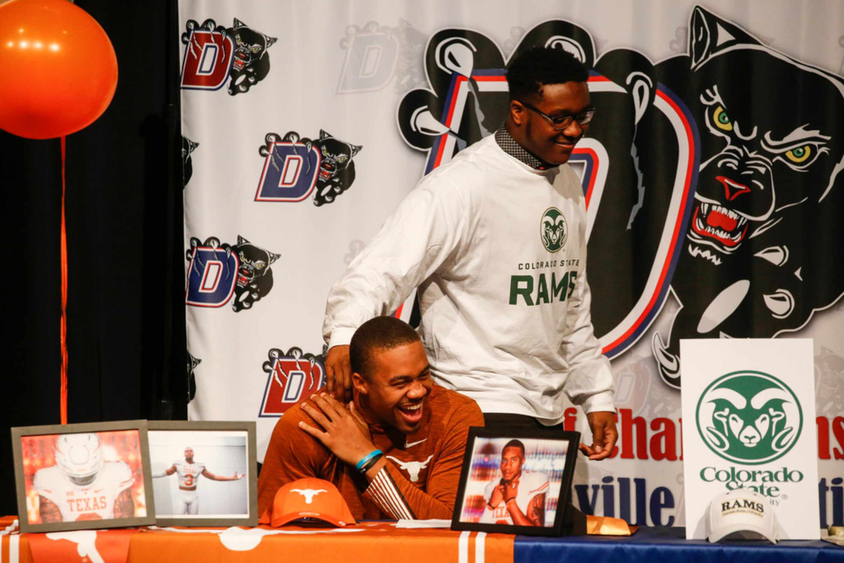 Duncanville quarterback Ja'Quinden Jackson, who signed with Texas, is embraced by James...