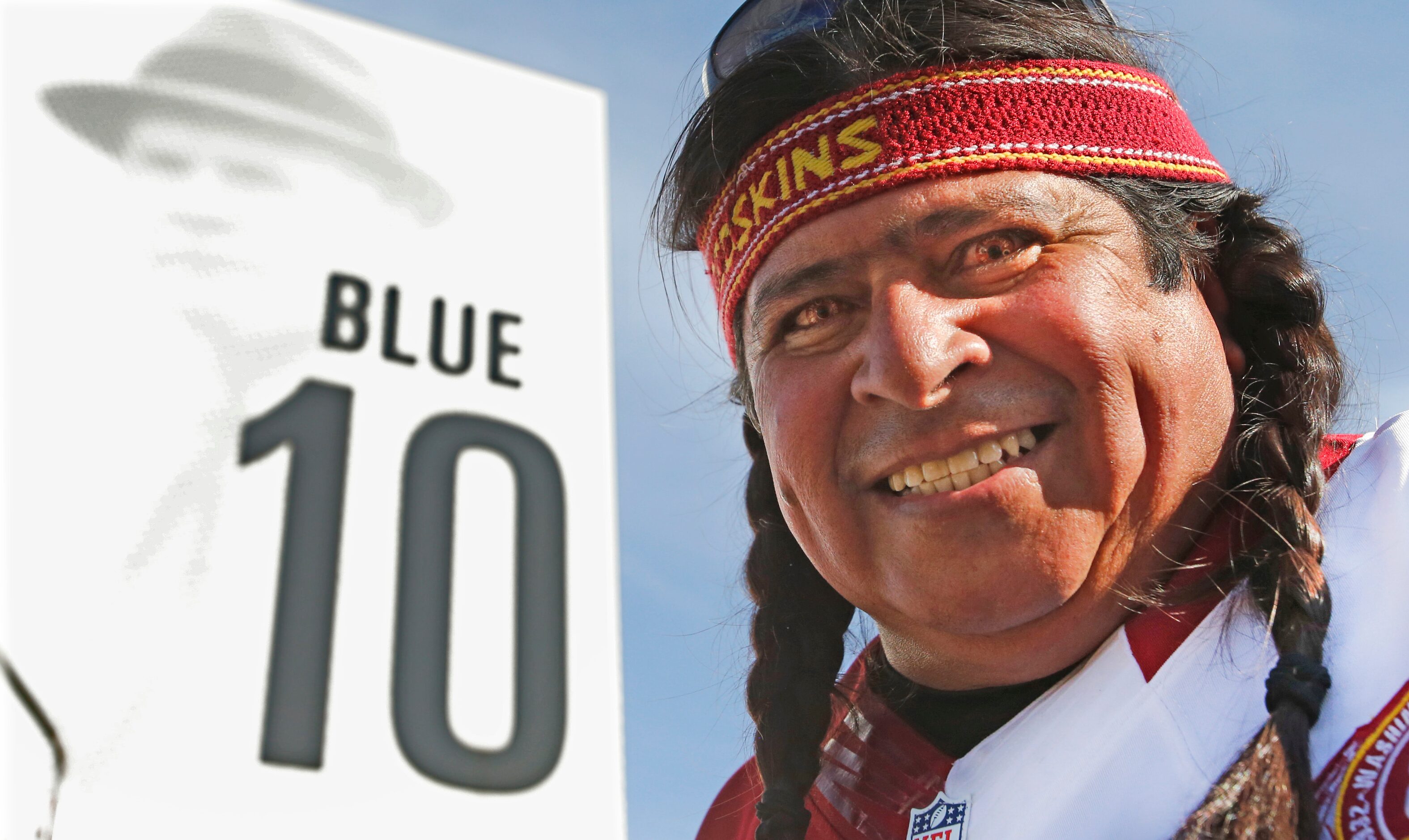 Leo Benavidez of Houston wears Redskin-tinted contacts as he tailgates with his family...