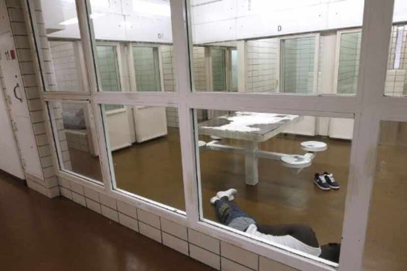  An inmate lies on the floor of one of the Dallas County Jail's mental health wings. (2012...
