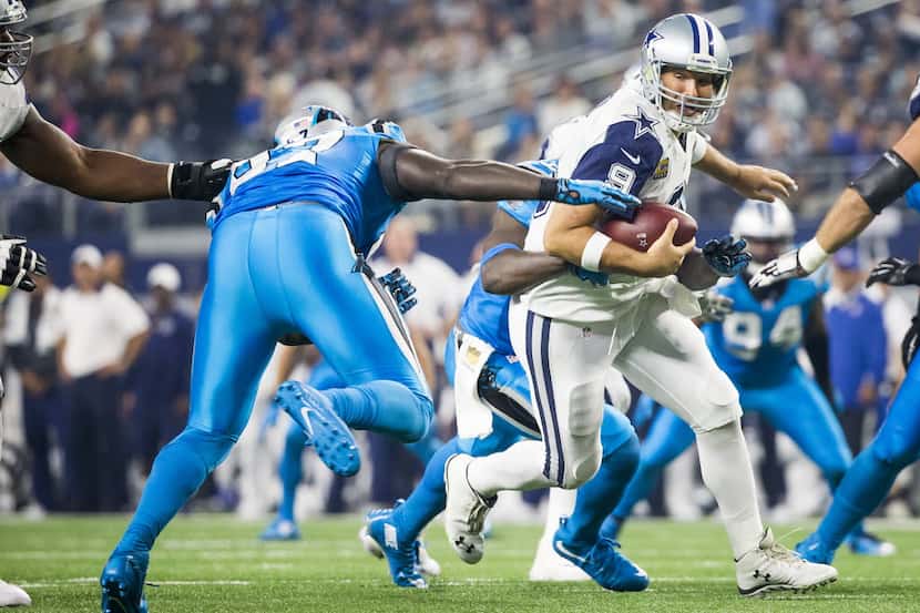 Dallas Cowboys quarterback Tony Romo (9) is sacked by Carolina Panthers outside linebacker...