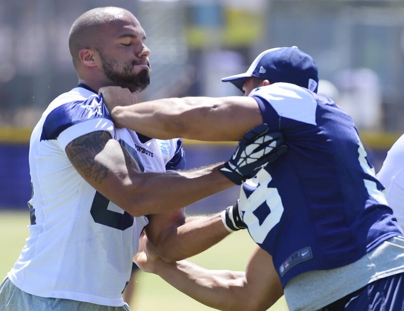 Tight end James Hanna (84) blocks defensive end Tyrone Crawford, right, during the walk-thru...