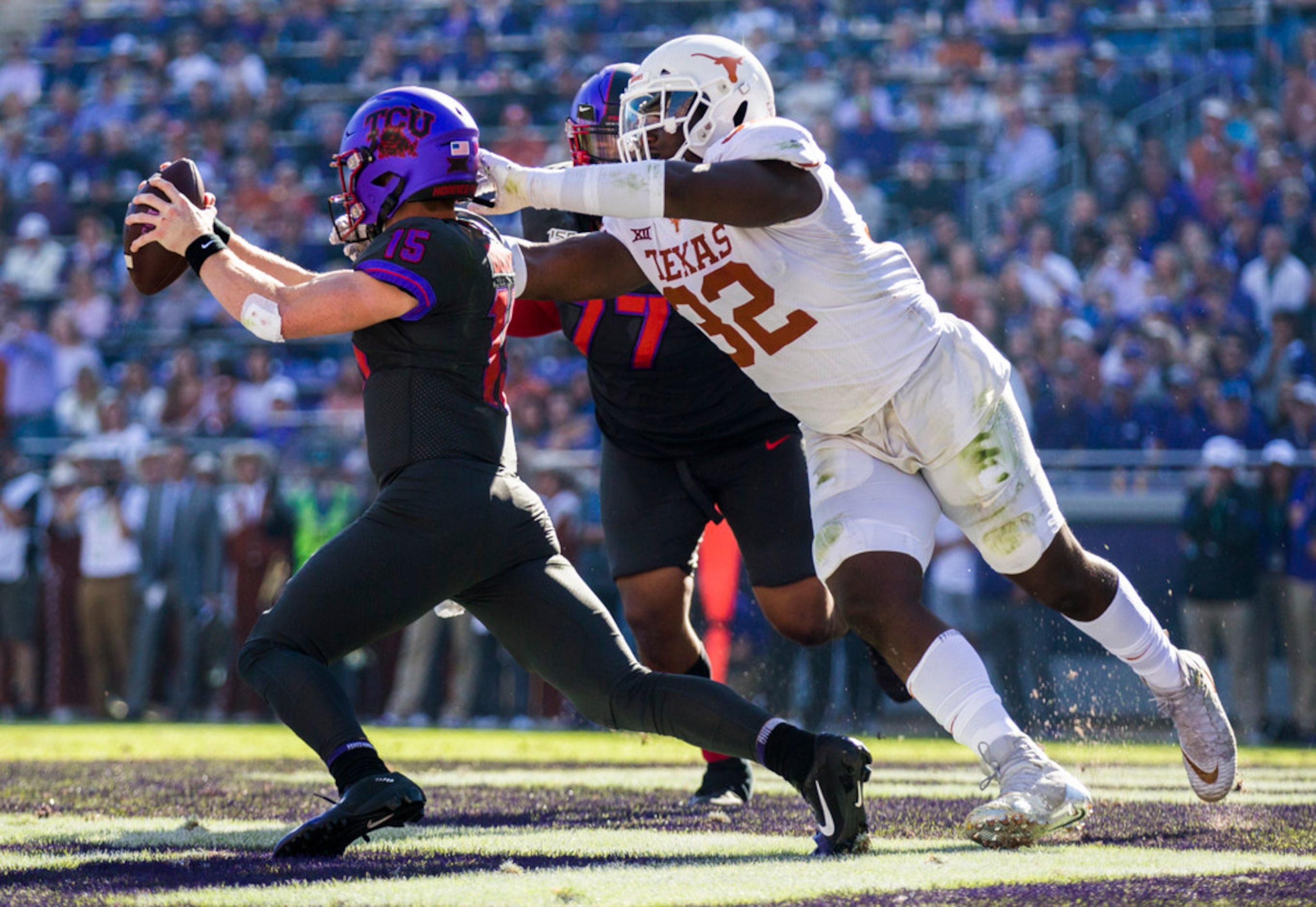 TCU Horned Frogs quarterback Max Duggan (15) avoids a safety attempt by Texas Longhorns...