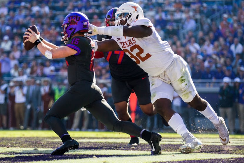 TCU Horned Frogs quarterback Max Duggan (15) avoids a safety attempt by Texas Longhorns...