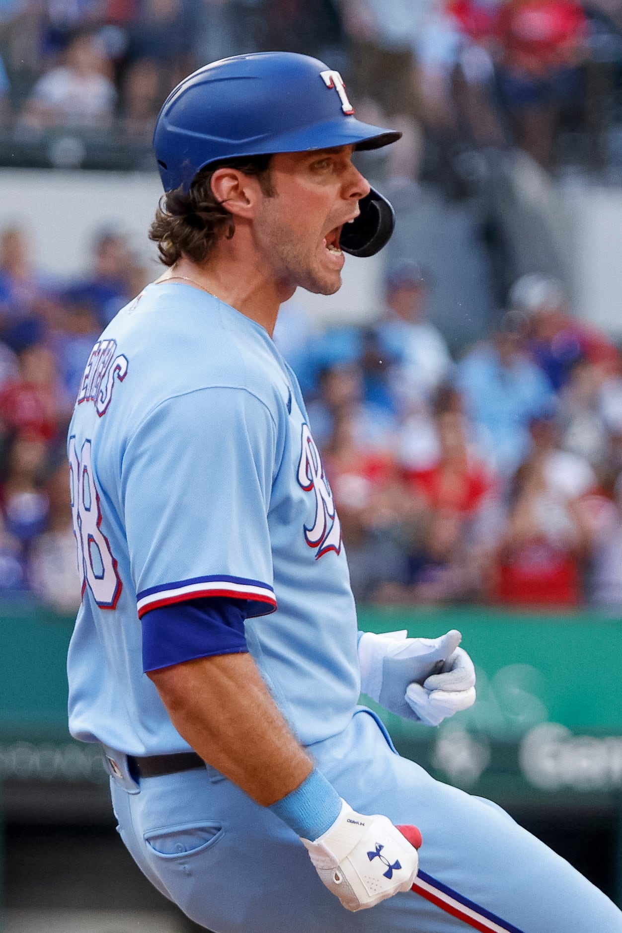 Texas Rangers designated hitter DJ Peters (38) reacts after flying