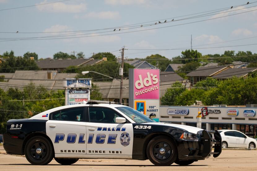 A Dallas Police vehicle sits in one of the parking lots at the Forest-Audelia intersection.