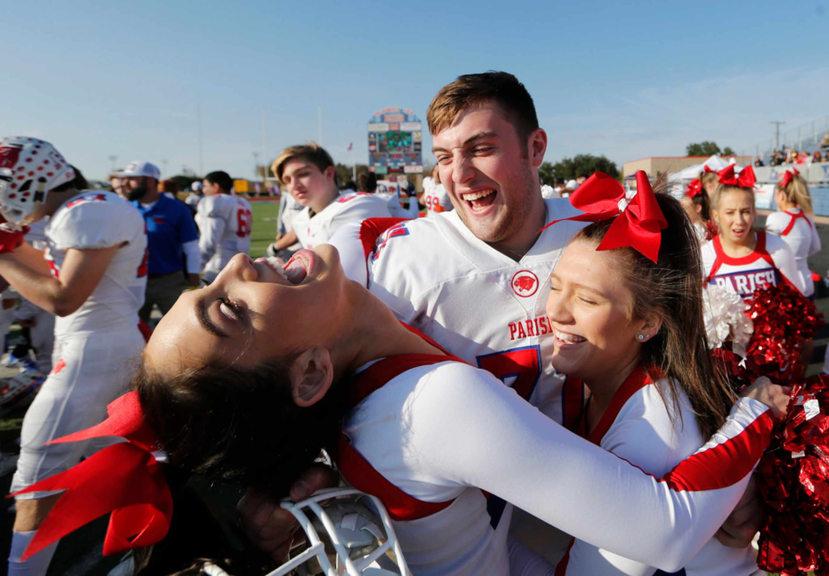 Parish Episcopal's Miles Cuban (71) shares a laugh with cheerleaders in celebration after...