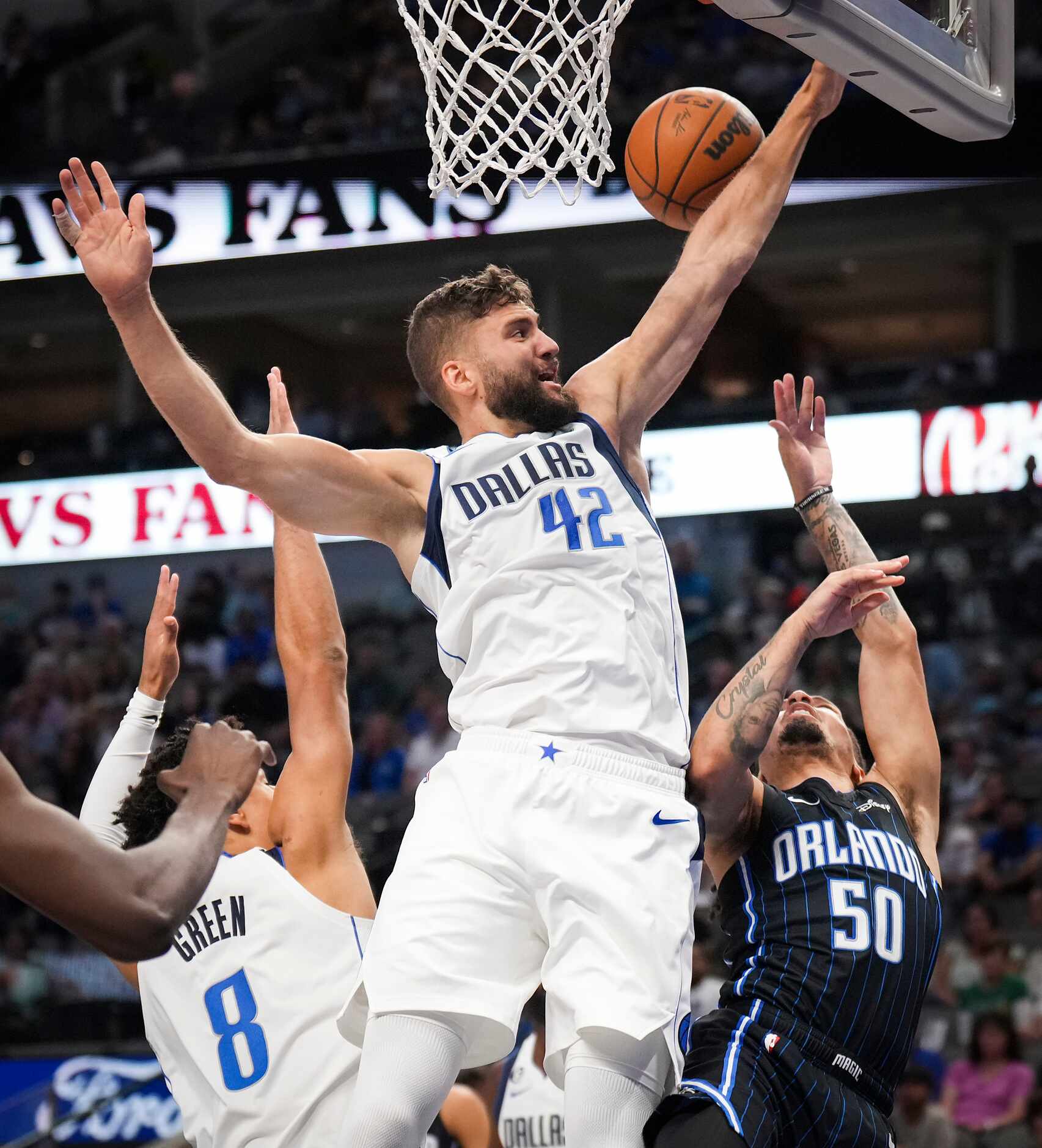 Orlando Magic guard Cole Anthony (50) is fouled by Dallas Mavericks forward Maxi Kleber (42)...