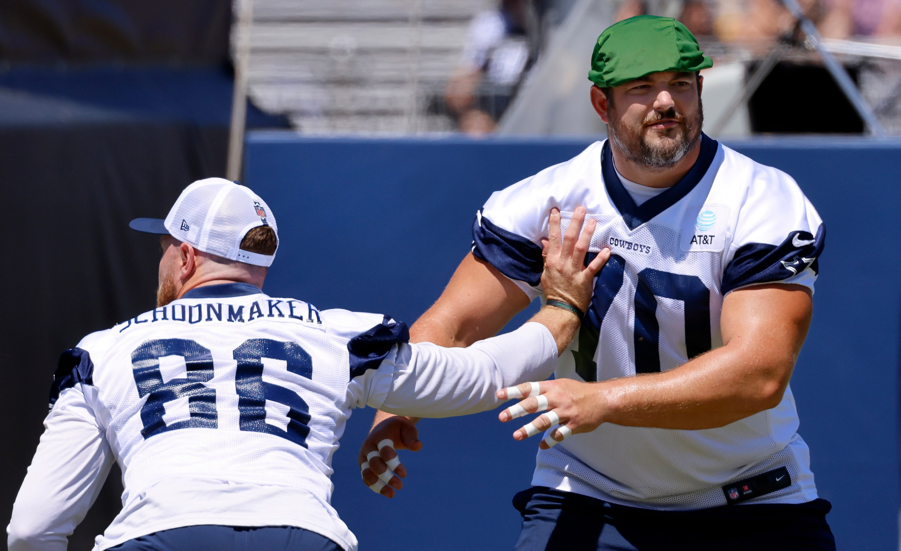 Dallas Cowboys guard Zack Martin (70) comes off the block by tight end Luke Schoonmaker (86)...