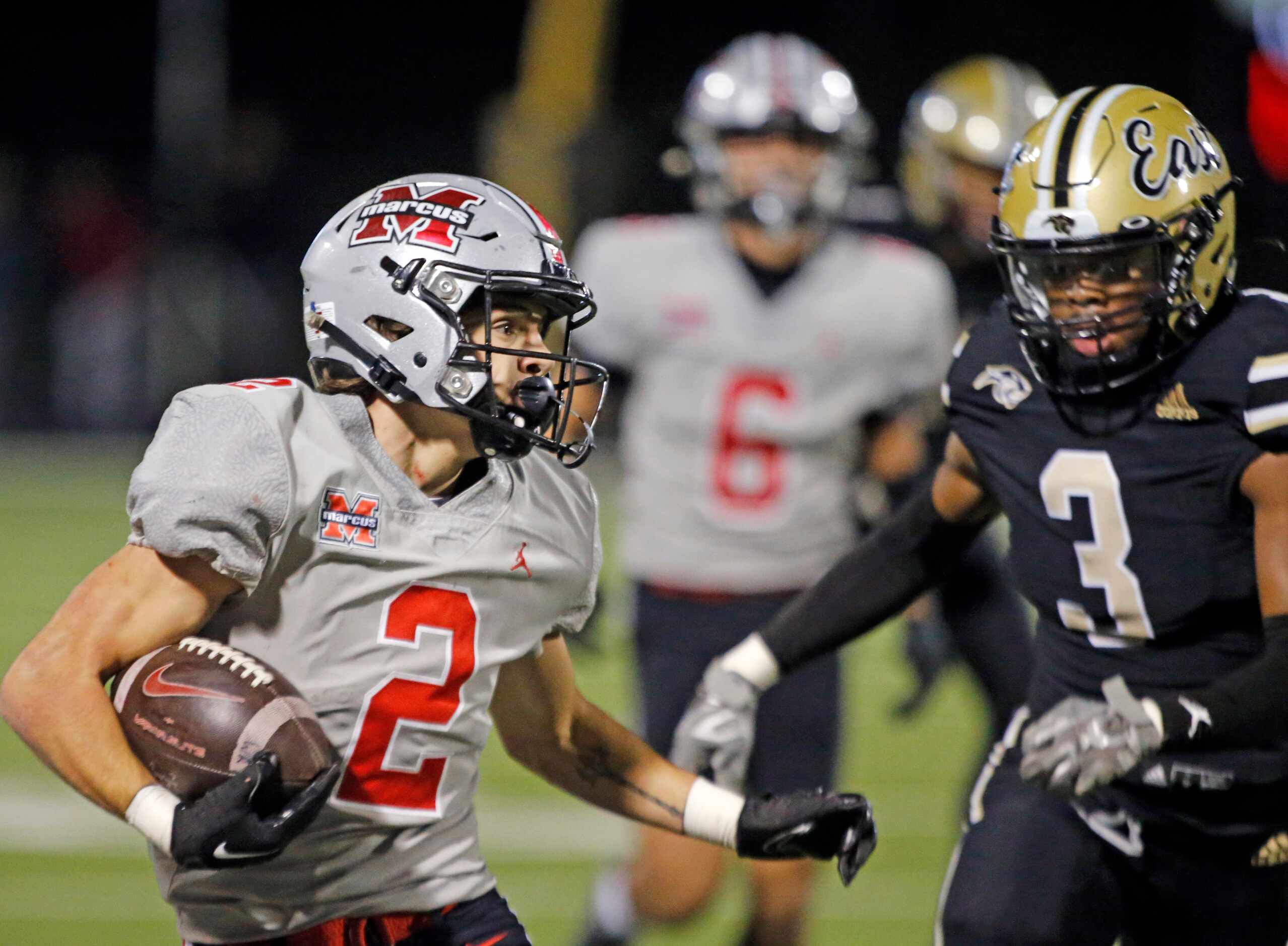 Flower Mound Marcus RB Karic Grennan (2) gets a couple of yards, as Plano East high defender...