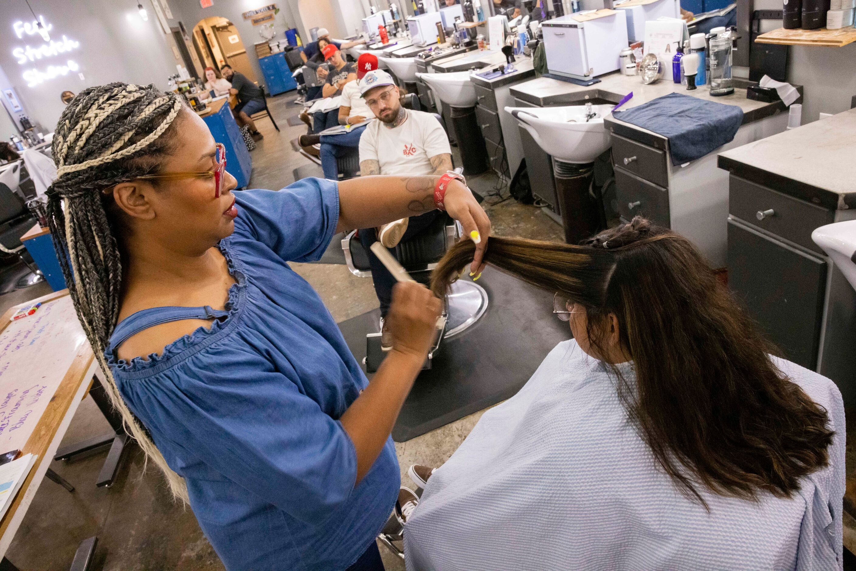 Instructor Kathia Santana demonstrates how layering works while using student Cynthia...