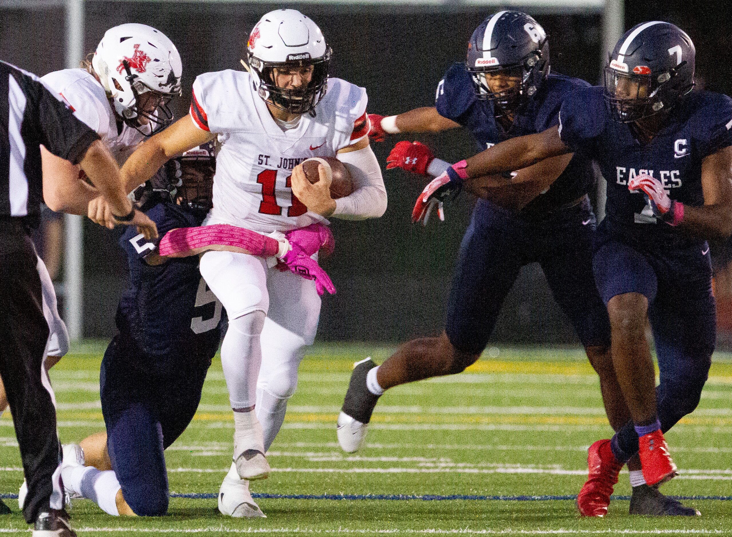 Houston St. Johns senior quarterback John Perdue (11) runs up the middle for positive...