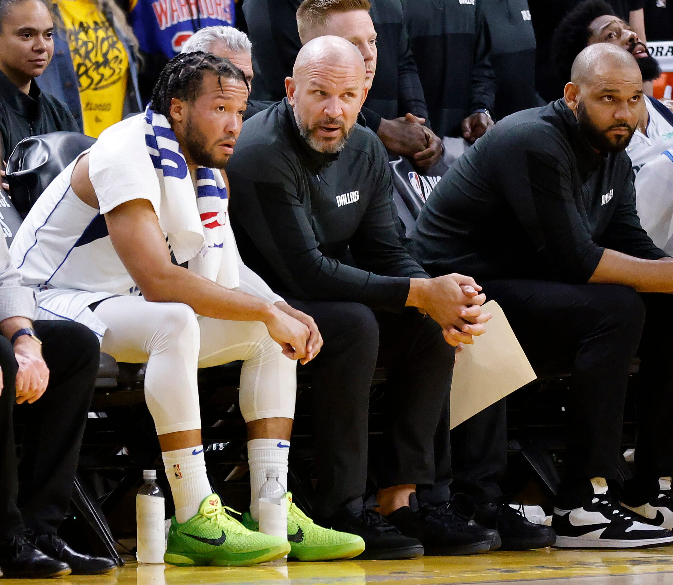 Dallas Mavericks head coach Jason Kidd (center) visits with guard Jalen Brunson (13) late in...