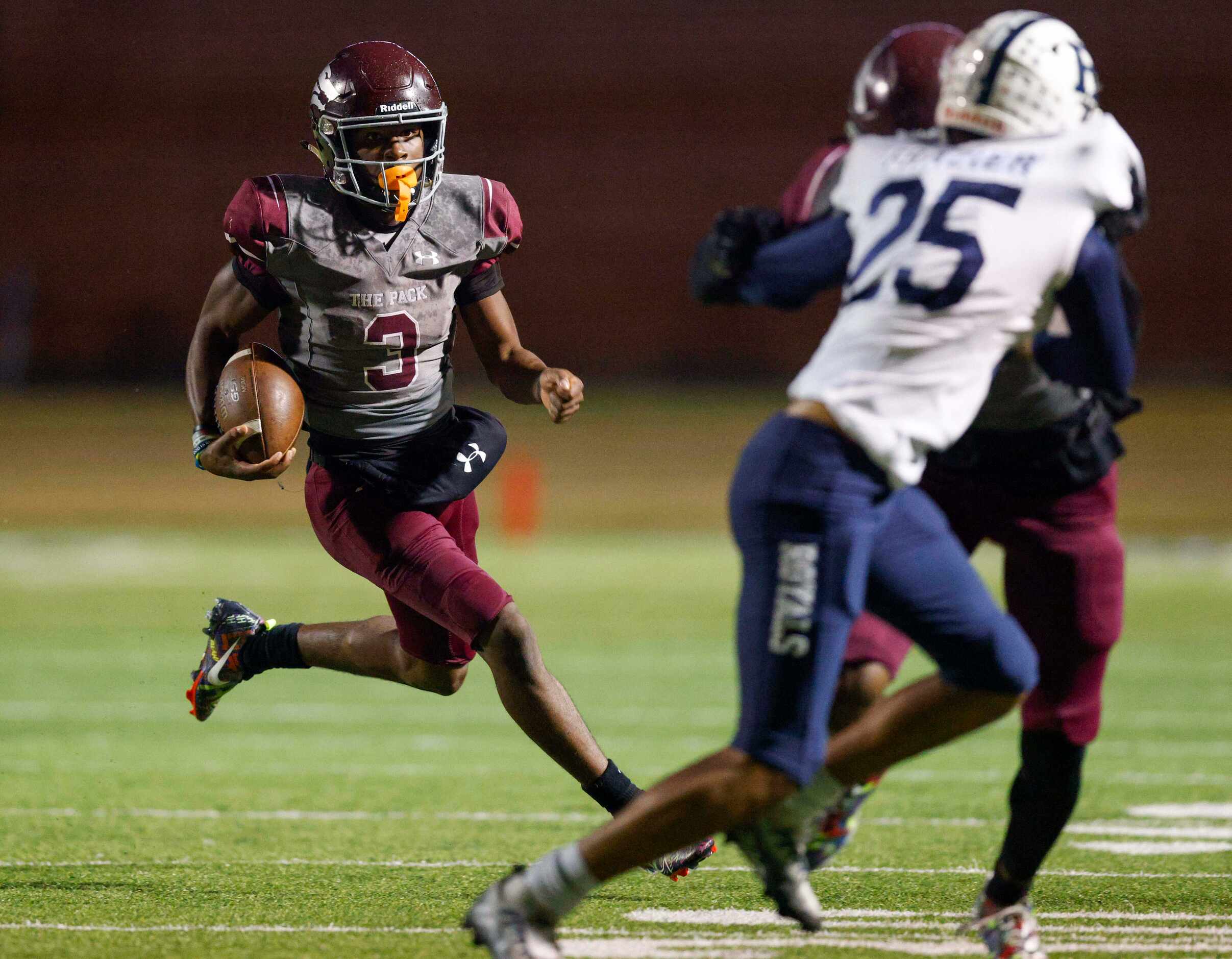 Mansfield Timberview quarterback Cameron Bates (3) runs towards a block and Richland...