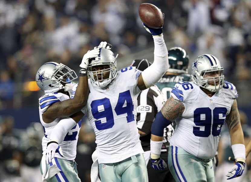 FILE - Cowboys cornerback Morris Claiborne (24) celebrates with defensive end DeMarcus Ware...