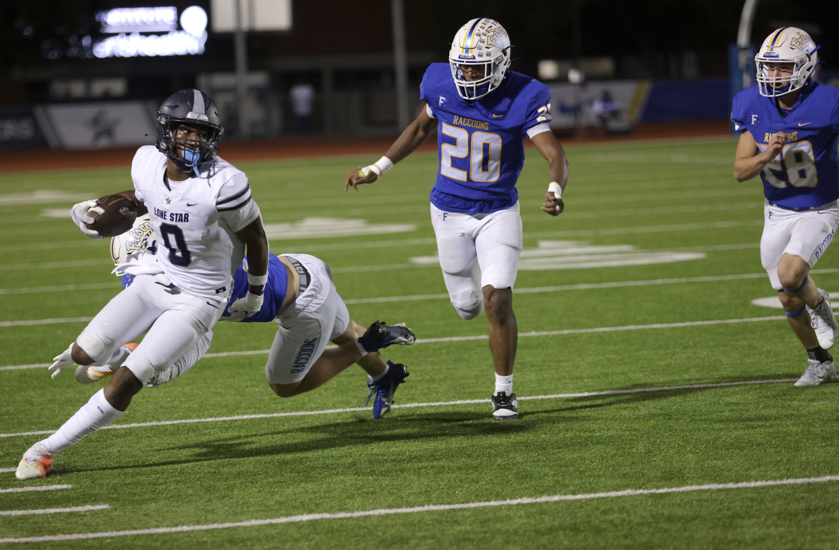 Lone Star player #0 Davian Groce avoids a tackle during the Frisco Lone Star High School...