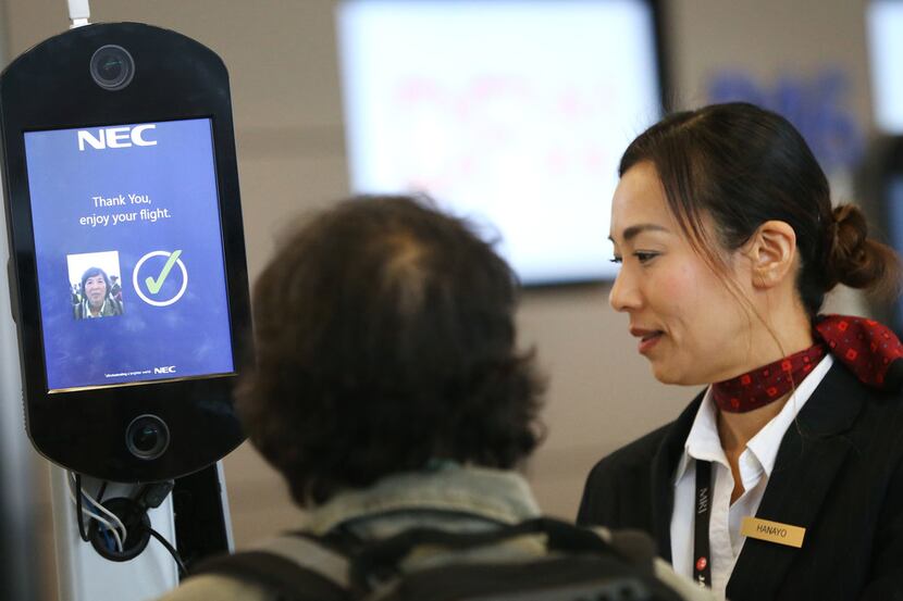 Hanayo Yoon, a customer service agent with Japan Airlines, helps a passenger use new...