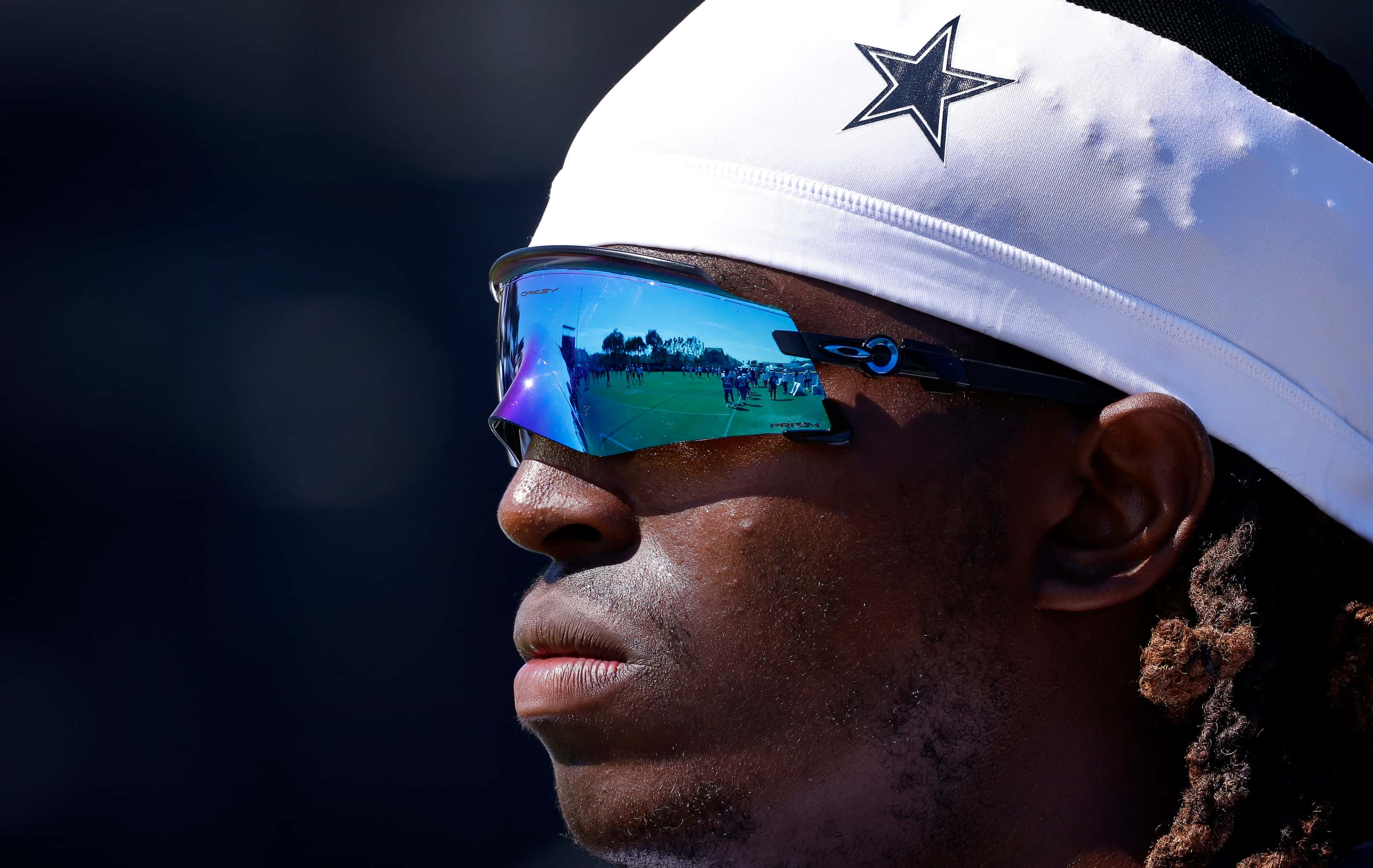 The field is reflected in Dallas Cowboys tackle Tyler Guyton’s sunglasses during a mock game...