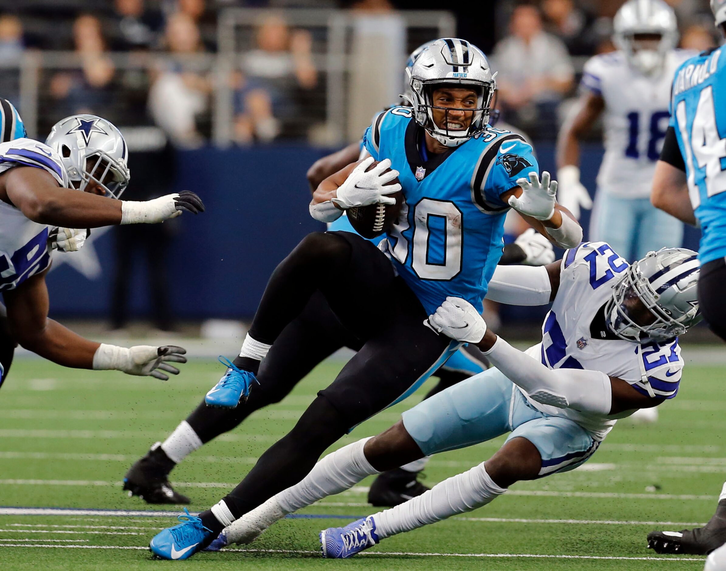 Carolina Panthers running back Chuba Hubbard (30) is tackled by Dallas Cowboys safety Jayron...