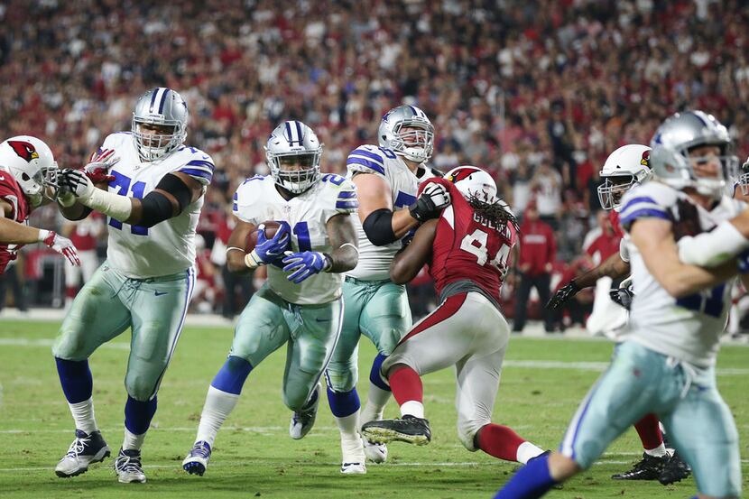 Dallas Cowboys running back Ezekiel Elliott (21) scores a rushing touchdown on an 8-yard run...
