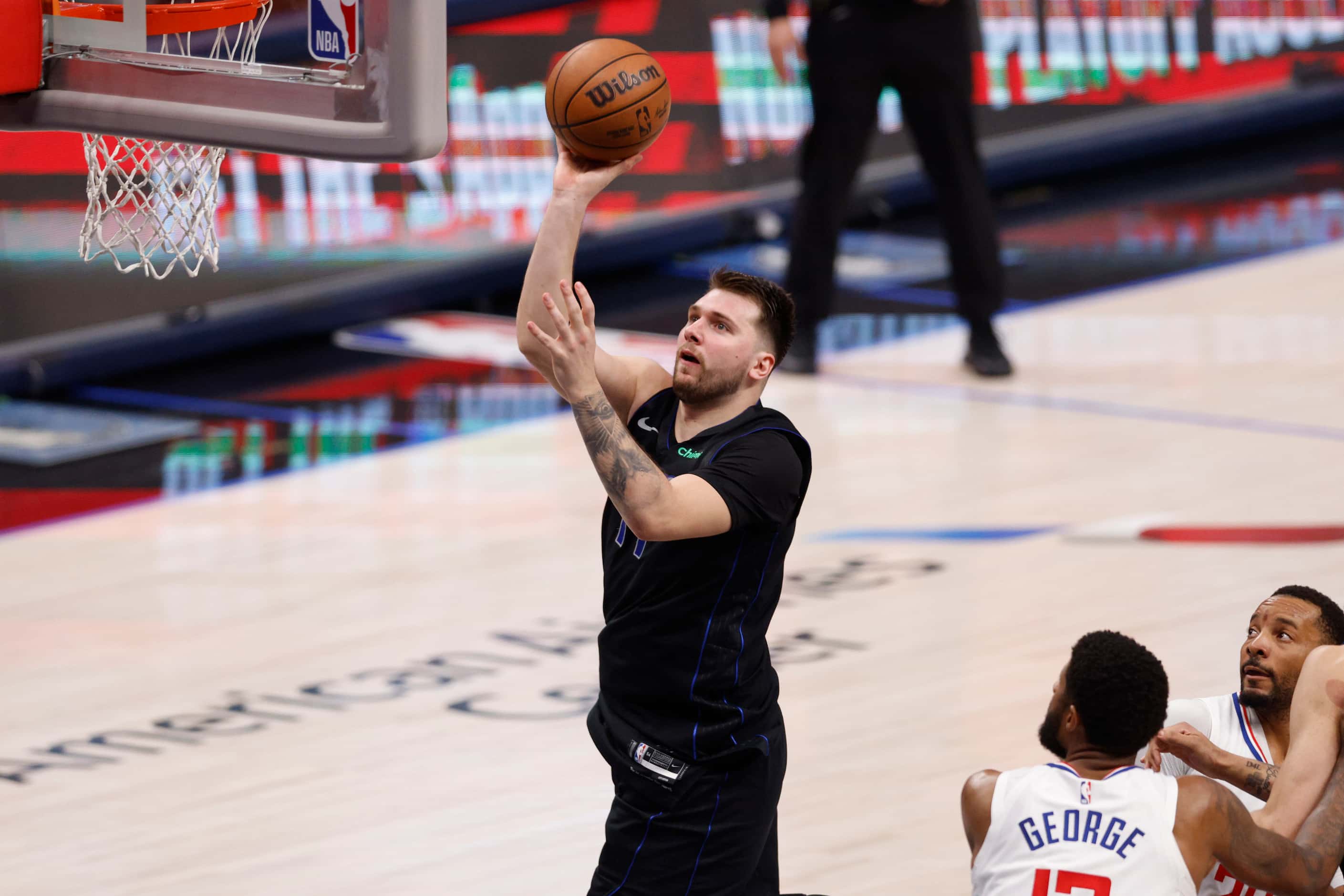 Dallas Mavericks guard Luka Doncic (77) floats a shot towards the basket as LA Clippers...