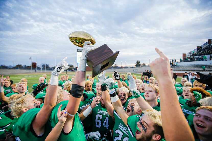 TXHSFB Southlake Carroll celebrates winning the Class 6A Division I area-round playoff high...