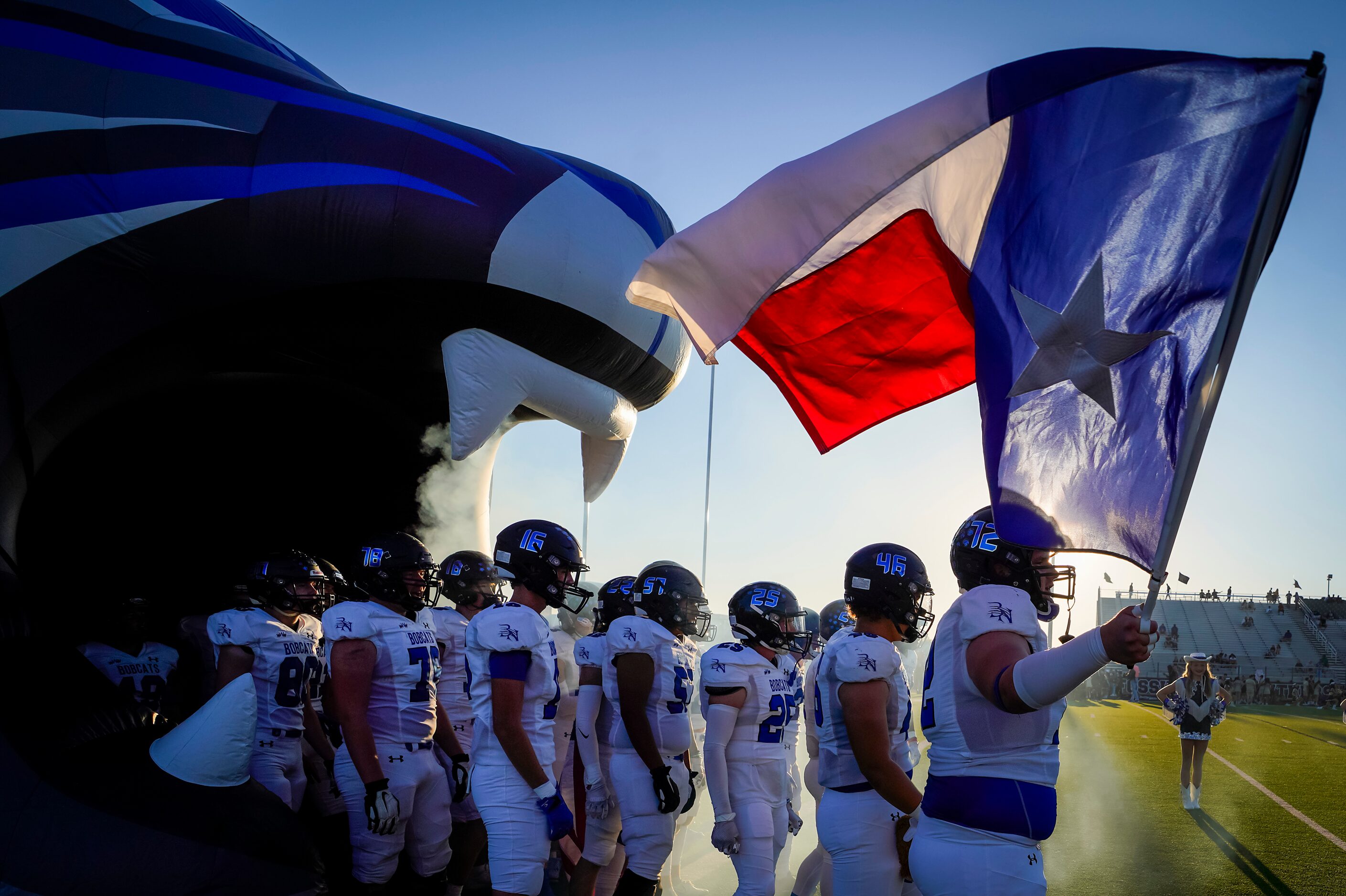 Trophy Club Byron Nelson’s Abrahim Sakiri (72) carries the Texas flag as he prepares to lead...