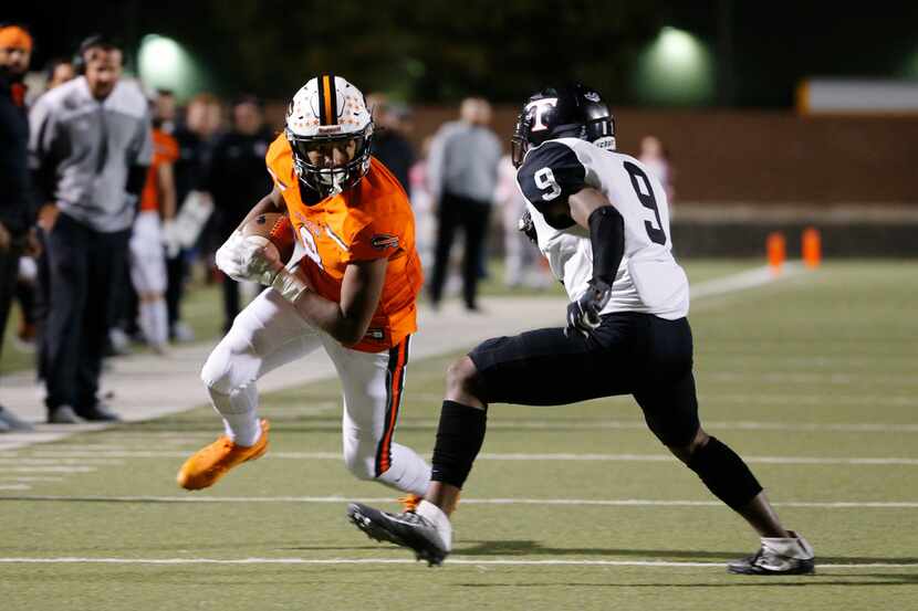 FILE - Haltom receiver Jace Washington catches a pass in front of Euless Trinity defender...